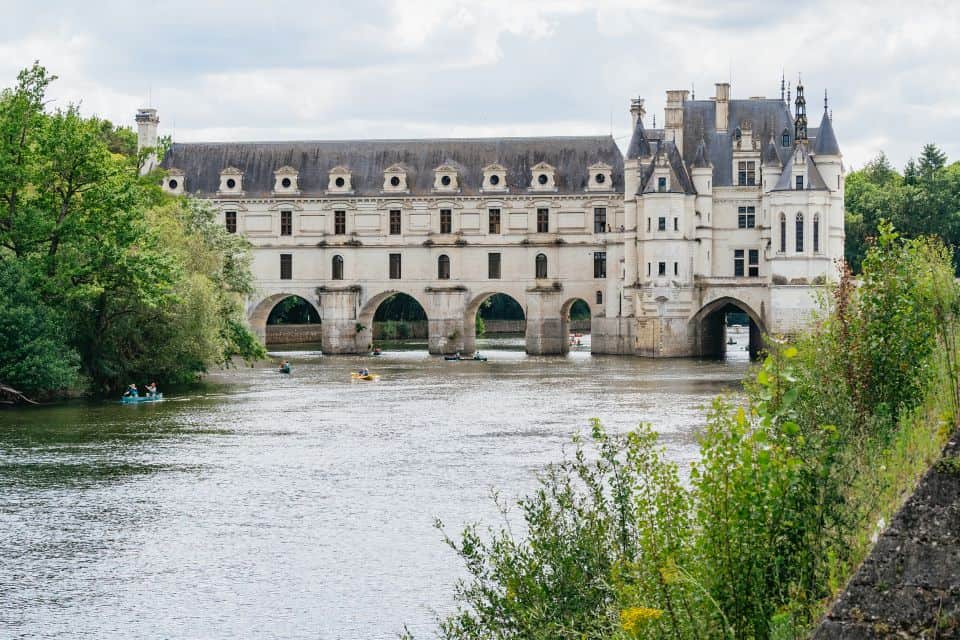 A castle near a river offering wine tours from Paris.