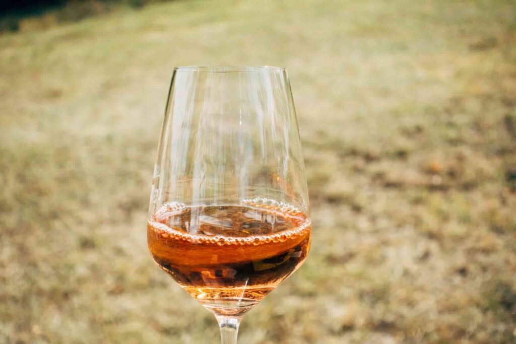 A glass of armagnac in a field.