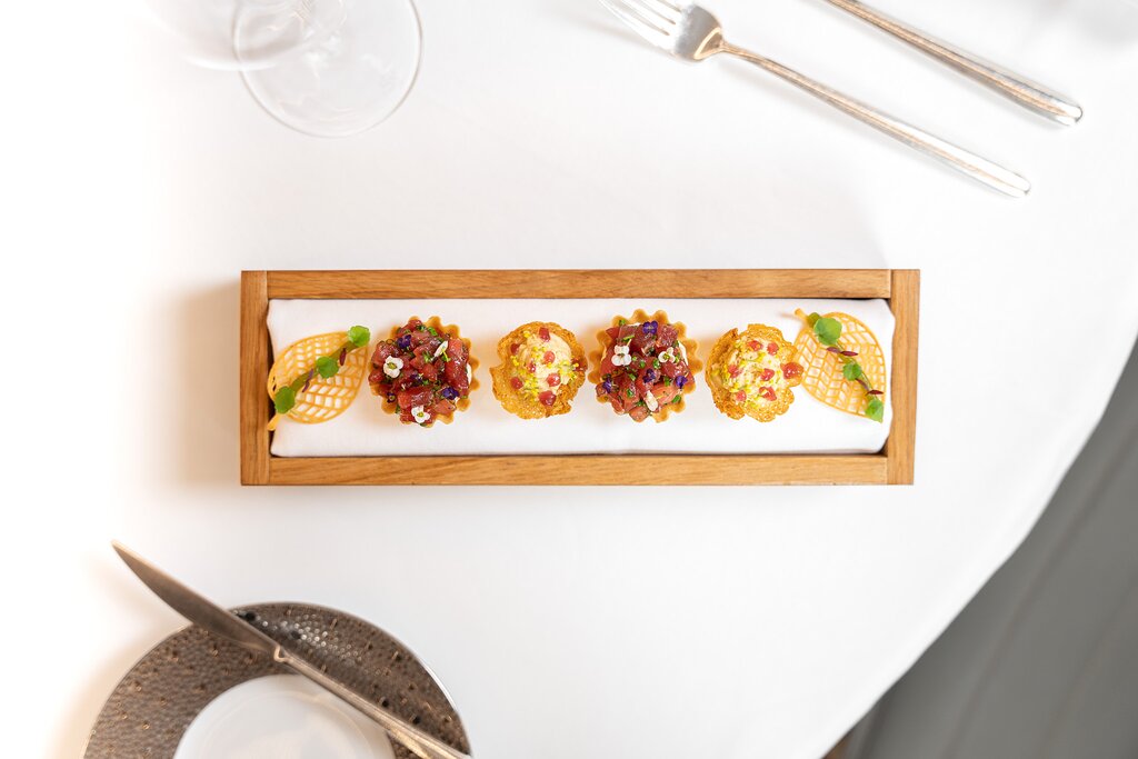 A plate of food on a table at a restaurant in Reims, set with a knife and fork.