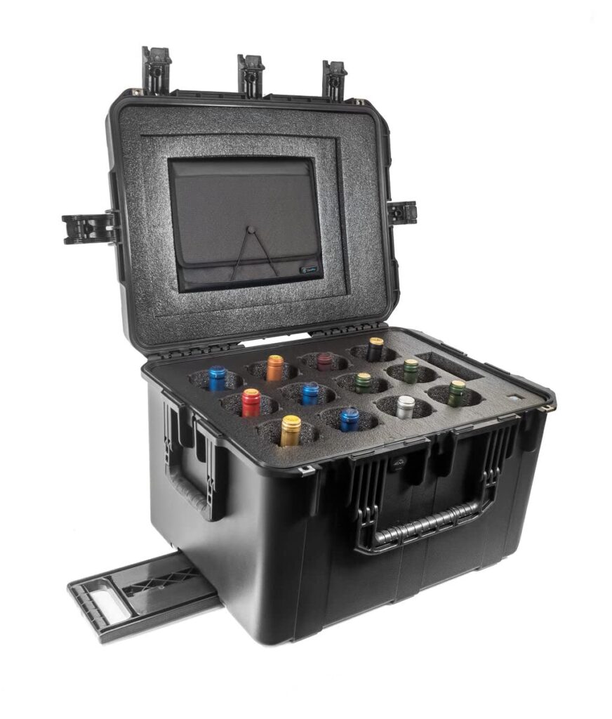 A black wine suitcase with several electronic devices in it.