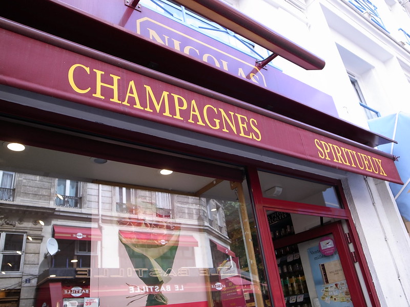 A storefront in Reims with a sign that says champagnes.