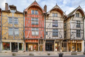 A row of colorful wooden buildings on a street in Troyes.