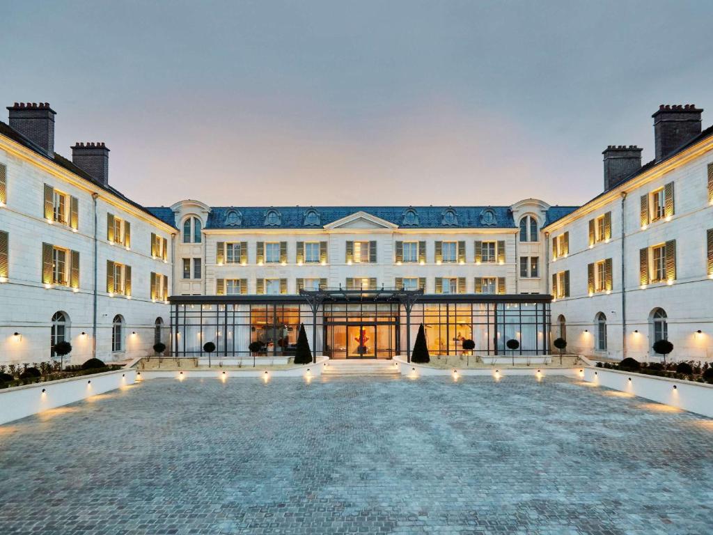 The entrance to a large hotel at dusk.