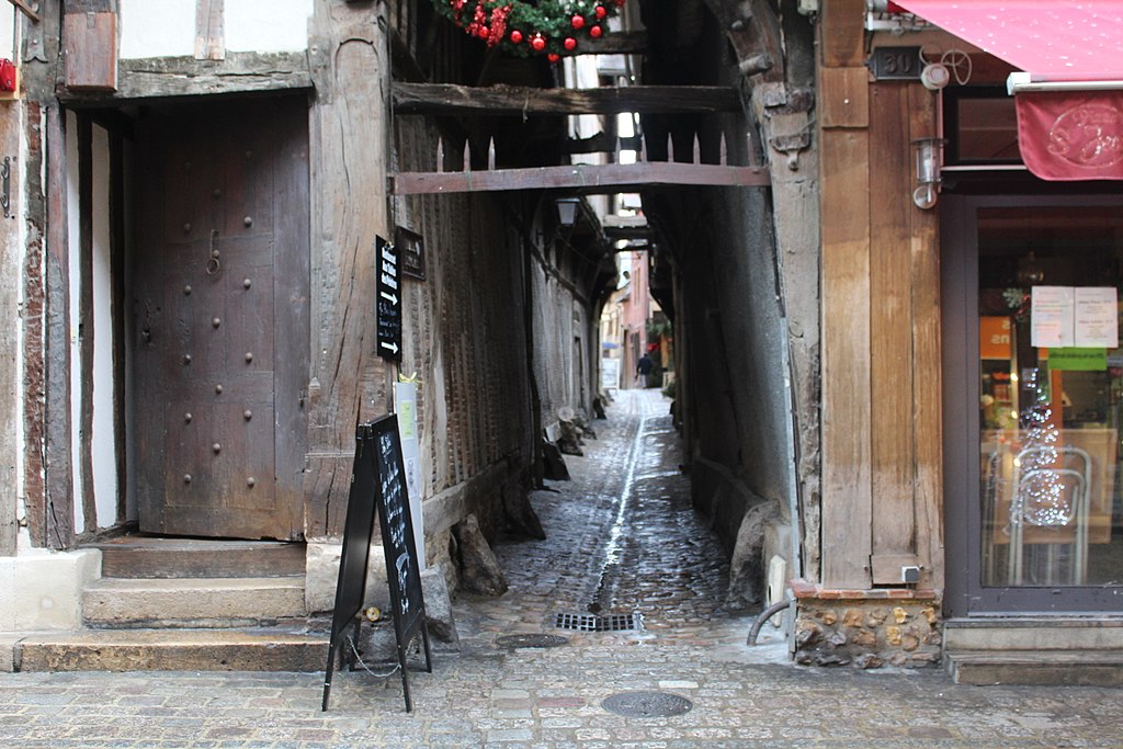 Discover a hidden gem in Troyes - the charming narrow alleyway with a wooden door.