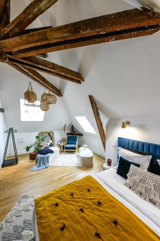A bedroom with wooden beams and a bed.
