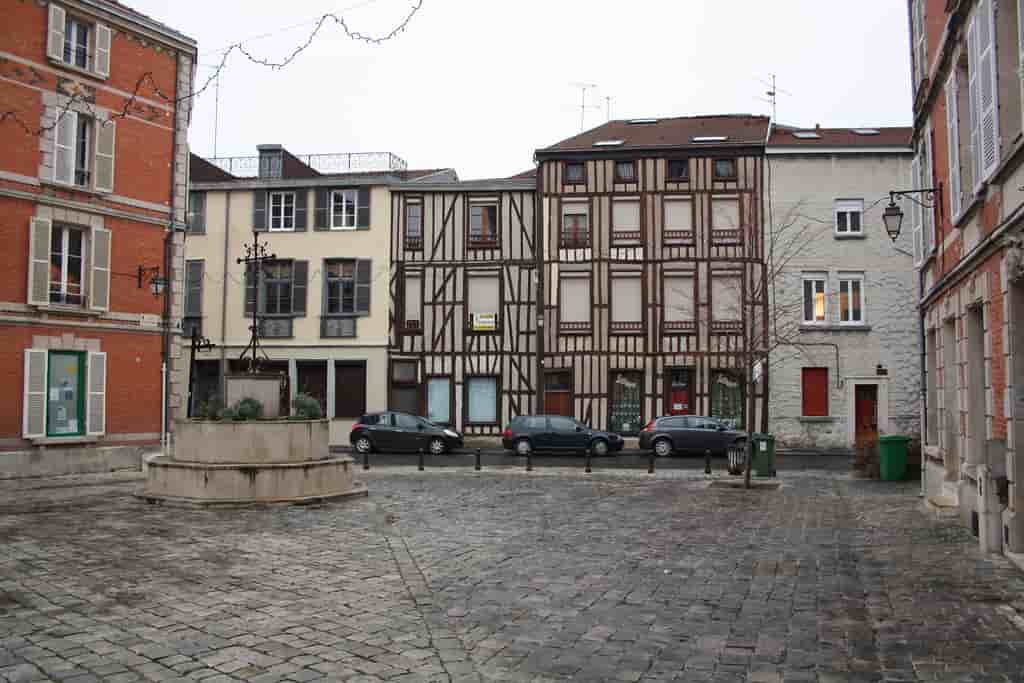 A cobblestone street with buildings in the background.