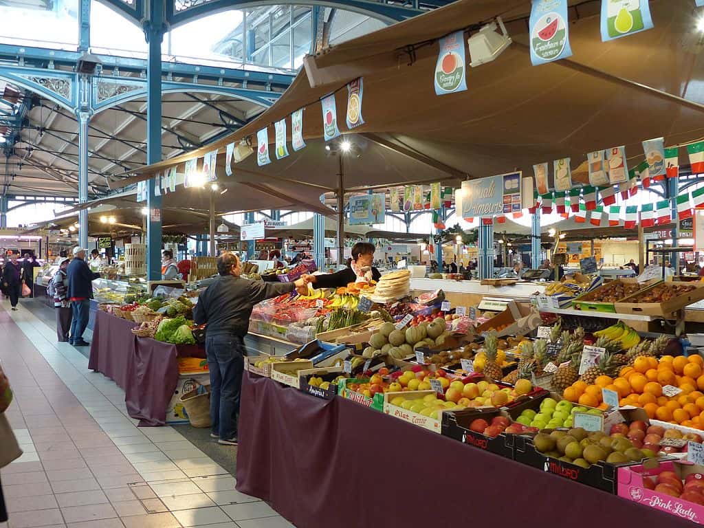 A vibrant market in Troyes offering a plethora of fresh fruit and vegetables.