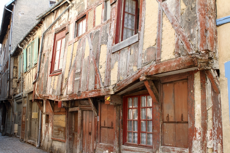 An old wooden building on a cobbled street.
