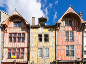 A row of colorful wooden buildings on a street.