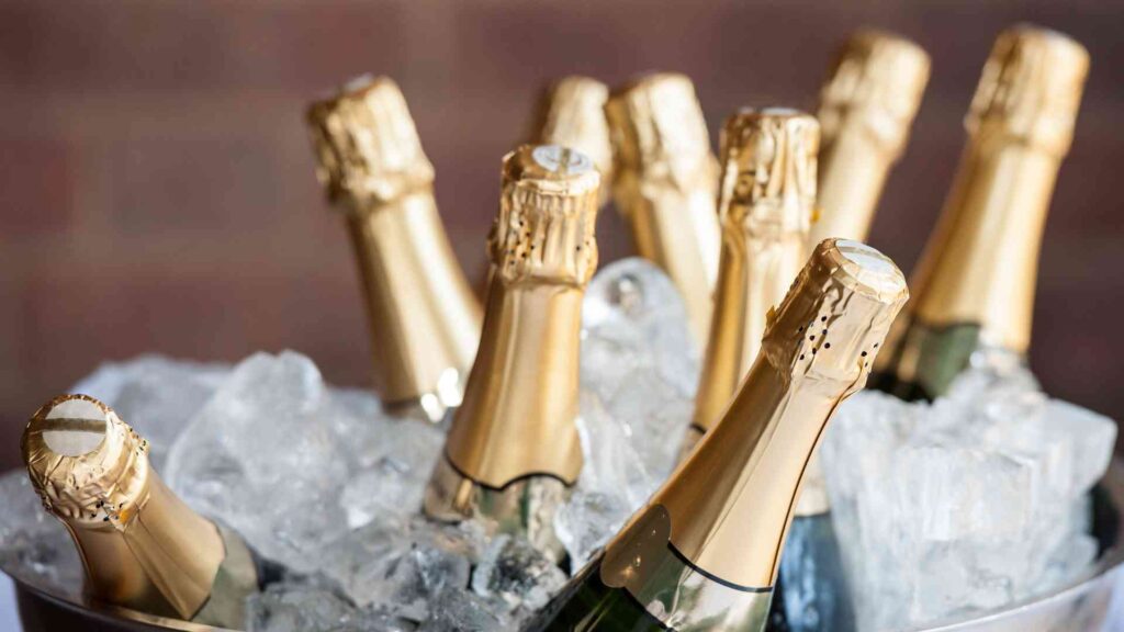 Champagne bottles in a bucket of ice.